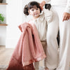 Little girl holding a gorgeous salmon receiving blanket.