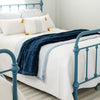 A Toddler Navy Colored Lush Luxury Saranoni Blanket laying on a bed. The soft blanket is small blanket and a baby blanket or toddler blanket.