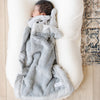 A newborn baby boy sleeps under a Gray Colored Lush Saranoni blanket. The soft blanket is a small blanket and a baby blanket.