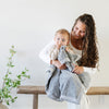 A mother holds her baby boy and a Luxury Receiving Gray Colored Lush Saranoni Blanket over her baby boy's lap. The soft blanket is a small blanket and a baby blanket or toddler blanket.