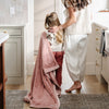 A little girl carries a Luxury Toddler Ballet Slipper (light pink) Colored Lush Saranoni Blanket. The soft blanket is a toddler blanket or baby blanket.