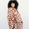 Woman wrapped in a cozy throw blanket in the Khmer print that is double layer bamboni.