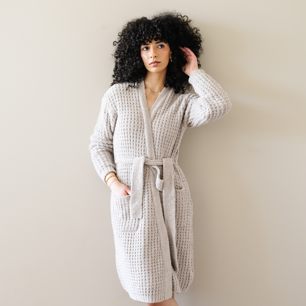 Woman wearing oatmeal tan waffle knit robe. 