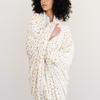 Woman wrapped in a floral printed blanket in the minky stretch fabric. 