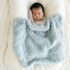 Baby boy snuggled with Heather Blue Dream Mini Baby Blanket.