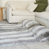 Two faux fur sleeping bags. The sleeping bags are from Saranoni and are a light grey blended with dark gray color.