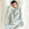 Baby Boy snuggled with Sweet Mint Dream Mini Baby Blanket.