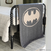 A black and light gray double-layer Bamboni® blanket with a Batman™ icon on it. The soft blanket is a luxury blanket and a throw blanket as well as a Saranoni blanket. 