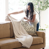 A woman styles a Bamboni® blanket by Saranoni. This ultra-soft blanket is a cream blanket and made from a premium blend of bamboo rayon and poly microfiber, offering a lightweight, breathable, and fluffy feel. Perfect as a extra large blanket, luxury blanket, or soft blanket, it adds warmth and elegance to any living room, bedroom, or home décor setting. Designed for ultimate comfort, this buttery-soft Saranoni blanket is ideal for gifting. Enjoy this cozy blanket for years to come!