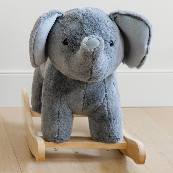 A close-up view of a soft gray plush elephant rocker, featuring large floppy ears and a friendly expression. The plush texture invites touch, making it an ideal addition to any child's playroom. Perfect for parents looking for high-quality, cuddly rocking toys that encourage imaginative play and provide comfort for young children.