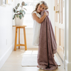 A little girl holds a Toddler Bloom (dusty purple) Colored Lush Luxury Saranoni Blanket. The soft blanket is small blanket and a baby blanket or toddler blanket.