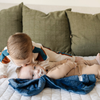 Two little boys and a mini blanket that is a navy blanket. The soft blanket is a lush blanket and a baby blanket as well as a Saranoni blanket. This cozy blanket is a luxury blanket for babies and is so soft. 