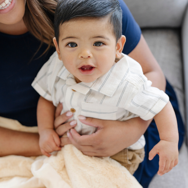 A mother holds her baby boy and a Mini Chiffon (light yellow) Colored Lush Saranoni Blanket. The soft blanket is a small blanket and a baby blanket.