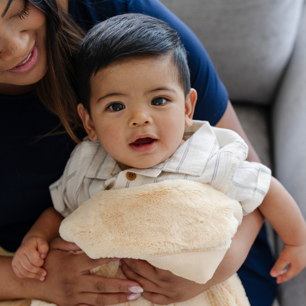 A mother holds her baby boy and a Mini Chiffon (light yellow) Colored Lush Saranoni Blanket. The soft blanket is a small blanket and a baby blanket.