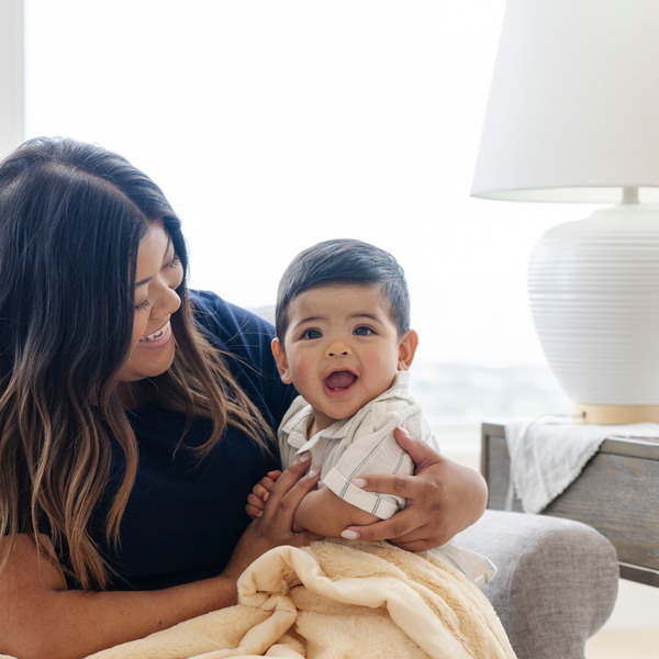 A mother holds her baby boy and a Mini Chiffon (light yellow) Colored Lush Saranoni Blanket. The soft blanket is a small blanket and a baby blanket.