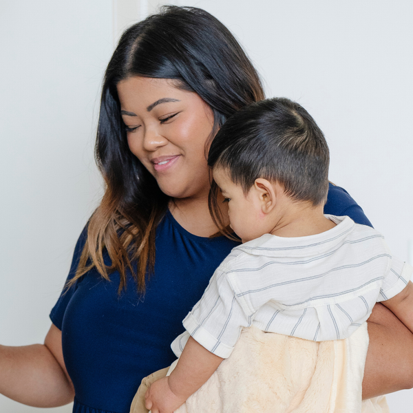 A mother holds her baby boy and a Mini Chiffon (light yellow) Colored Lush Saranoni Blanket. The soft blanket is a small blanket and a baby blanket.