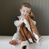 A little boy holds a satin back blanket. The lush blanket is brown with a cream satin border that has little trees on it. The satin back blanket is a lush blanket with a satin border and back. The soft blanket is a luxury blanket and a Saranoni blanket. This toddler blanket is an adorable baby blanket or toddler blanket and a great kids blanket.