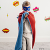 A little boy is wrapped in a receiving blanket with a Superman™ icon on it. The soft blanket is light blue and red. This kids blanket is a luxury blanket and a Saranoni blanket. The blanket is also a double-layer Bamboni® blanket. 