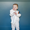 A little boy holds a buttery-soft Saranoni blanket, featuring a breathable, plush waffle texture in a soothing white hue. This luxury mini blanket is the best baby blanket as a newborn blanket and infant blanket—perfect as a cozy blanket for snuggles or a must-have infant blanket. Designed for softness and comfort, this plush baby blanket makes an ideal baby boy gift or gift for new moms. Enjoy this luxury blanket! 