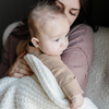 A mother holds her little boy in a buttery-soft Saranoni blanket, featuring a breathable, plush waffle texture in a soothing white hue. This luxury mini blanket is the best baby blanket as a newborn blanket and infant blanket—perfect as a cozy blanket for snuggles or a must-have infant blanket. Designed for softness and comfort, this plush baby blanket makes an ideal baby boy gift or gift for new moms. Enjoy this luxury blanket! 