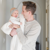 A father holds his little girl in a buttery-soft Saranoni blanket, featuring a breathable, plush waffle texture in a soothing white hue. This luxury toddler blanket is the best kids blanket as a baby blanket or toddler blanket—perfect as a cozy blanket for snuggles or a must-have infant blanket. Designed for softness and comfort, this plush toddler blanket makes an ideal toddler gift. Enjoy this luxury blanket!