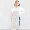 Woman holding a Saranoni blanket, specifically the tan marbled faux fur/minky throw, highlighting its ultra-soft texture and luxurious design. This plush throw blanket features a dual-texture blend of silky minky and cozy faux fur, creating the ultimate cozy throw blanket for home decor. Perfect luxury blanket for lounging or adding style to any space. Soft blanket, cozy blanket, plush throw—experience unmatched warmth with a Saranoni throw blanket.