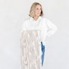 A woman holding a Saranoni blanket, specifically the tan marbled faux fur/minky extra large blanket, highlighting its ultra-soft texture and luxurious design. This plush blanket features a dual-texture blend of silky minky and cozy faux fur, creating the ultimate cozy blanket for home decor. Perfect luxury blanket for lounging or adding style to any space. Soft blanket, cozy blanket—experience unmatched warmth with a Saranoni blanket. 