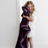 A little girl holds a Toddler Aubergine (deep purple) Colored Lush Luxury Saranoni Blanket. The soft blanket is a baby blanket or toddler blanket.