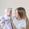 A mother holds her baby girl and a buttery-soft Saranoni blanket, featuring a breathable, plush waffle texture in a soothing light purple hue. This luxury mini blanket is the best baby blanket as a newborn blanket and infant blanket—perfect as a cozy blanket for snuggles or a must-have infant blanket. Designed for softness and comfort, this plush baby blanket makes an ideal baby boy gift or gift for new moms. Enjoy this luxury blanket! 