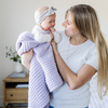 A mother holds her little girl in a buttery-soft Saranoni blanket, featuring a breathable, plush waffle texture in a soothing light purple hue. This luxury receiving blanket is the best baby blanket as a  newborn blanket, infant blanket, baby blanket, or toddler blanket—perfect as a cozy blanket for snuggles or a must-have infant blanket. Designed for softness and comfort, this plush baby blanket makes an ideal baby gift or gift for new moms. Enjoy this luxury blanket!