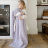 A little girl holds a buttery-soft Saranoni blanket, featuring a breathable, plush waffle texture in a soothing light purple hue. This luxury toddler blanket is the best kids blanket as a baby blanket or toddler blanket—perfect as a cozy blanket for snuggles or a must-have infant blanket. Designed for softness and comfort, this plush toddler blanket makes an ideal toddler gift. Enjoy this luxury blanket!