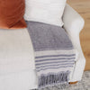 Luxurious throw blanket with fringe detail enhancing a living room decor - Saranoni