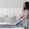 Soft chenille fringe blanket draped over a stylish bed - Saranoni