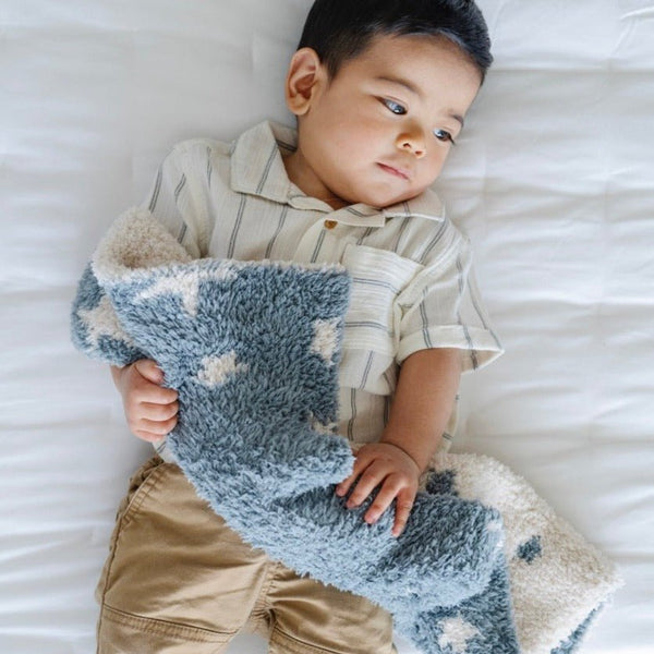 Adorable baby boy playing with super soft Nightfall DOUBLE - LAYER BAMBONI® MINI BLANKETS - Saranoni