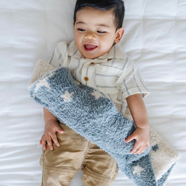 Baby boy giggling, playing with beautiful Nightfall DOUBLE - LAYER BAMBONI® MINI BLANKETS - Saranoni