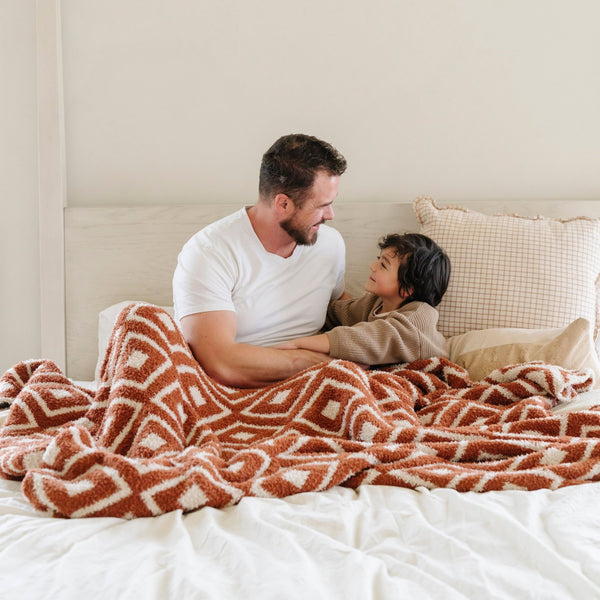 Dad and son snuggled together in cozy and warm Khmer DOUBLE-LAYER BAMBONI® XL BLANKETS - Saranoni