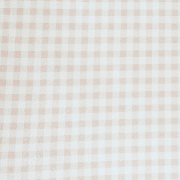 Close-up of Minky Stretch Luxe fabric in a delicate gingham pattern. Made from 94% polyester and 6% spandex, this ultra-soft, stretchy fabric is perfect for baby essentials like swaddles, changing pad covers, and crib sheets.