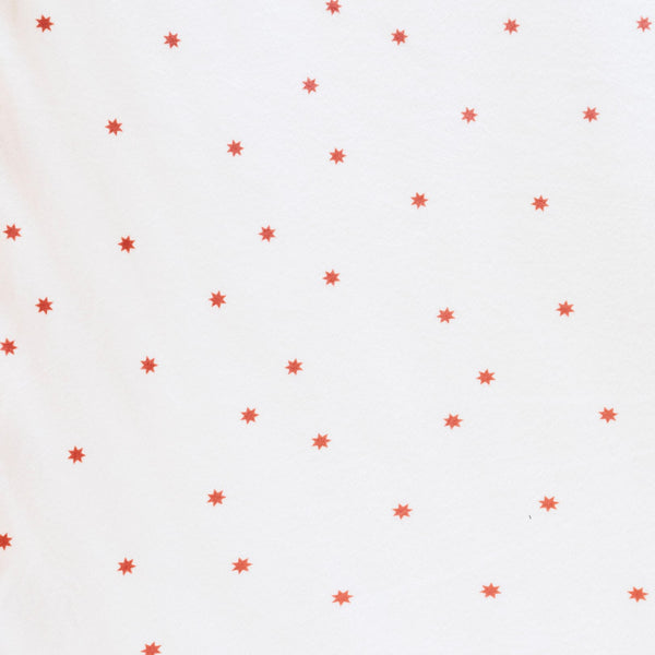 Close-up of Minky Stretch Luxe fabric in a delicate star pattern. Made from 94% polyester and 6% spandex, this ultra-soft, stretchy fabric is perfect for baby essentials like swaddles, changing pad covers, and crib sheets.