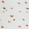 Close-up of Minky Stretch Luxe fabric in a delicate butterfly pattern, featuring multiple kind of butterflies. Made from 94% polyester and 6% spandex, this ultra-soft, stretchy fabric is perfect for baby essentials like swaddles, changing pad covers, and crib sheets.