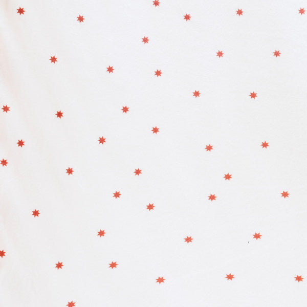 Close-up of Minky Stretch Luxe fabric in a delicate star pattern. Made from 94% polyester and 6% spandex, this ultra-soft, stretchy fabric is perfect for baby essentials like swaddles, changing pad covers, and crib sheets.