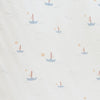 Close-up of Minky Stretch Luxe fabric in a delicate sail boat pattern. Made from 94% polyester and 6% spandex, this ultra-soft, stretchy fabric is perfect for baby essentials like swaddles, changing pad covers, and crib sheets.