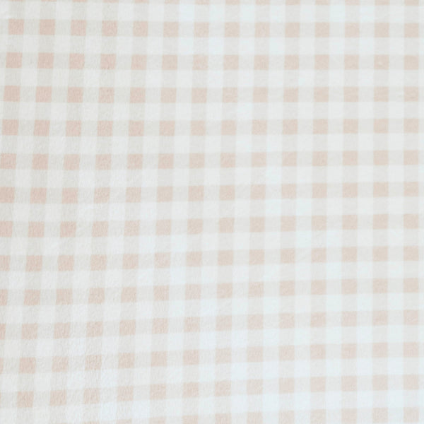 Close-up of Minky Stretch Luxe fabric in a delicate gingham pattern. Made from 94% polyester and 6% spandex, this ultra-soft, stretchy fabric is perfect for baby essentials like swaddles, changing pad covers, and crib sheets.