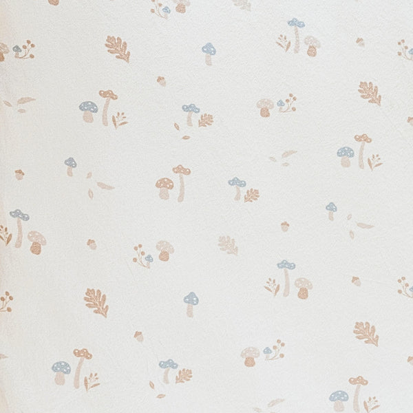 Close-up of Minky Stretch Luxe fabric in a delicate mushroom pattern. Made from 94% polyester and 6% spandex, this ultra-soft, stretchy fabric is perfect for baby essentials like swaddles, changing pad covers, and crib sheets.