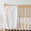 A Minky Stretch Luxe swaddle in a star pattern, featuring ultra-soft minky fabric with a luxurious stretch, perfect for keeping your baby cozy and comfortable. Ideal for newborns and infants is on a crib where the Minky Stretch Luxe crib sheet in a star pattern, designed with soft and stretchy minky fabric for ultimate comfort. Perfect fit for standard crib mattresses, offering a cozy and luxurious sleep environment for your baby.