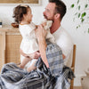 Dad and daughter playing with blue and white striped MINKY STRETCH RECEIVING BLANKETS - Saranoni