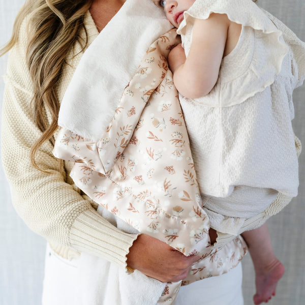 Soft and snuggly receiving blanket with a satin back, ideal for wrapping your baby in comfort and style.