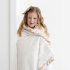 Young girl wrapped up in a cozy and luxurious floral satin back toddler blanket.