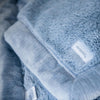 A picture of a baby blue soft lush fabric Saranoni Blanket.