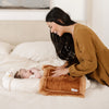 A mother smiles at her baby girl who has a Camel Colored Lush Saranoni Blanket. The soft blanket is a small blanket and a baby blanket.