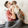 Dad snuggling with son in beautiful Charcoal Ribbed Bamboni Blanket